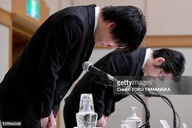 Koichiro Wada , president of Japan's virtual currency exchange Coincheck, and board member Yusuke Otsuka bow at the beginning of a press conference...