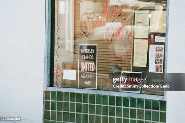 Sign reading Berkeley Stands United Against Hate in a shop window, part of a city-wide campaign in protest of alt-right demonstrations in the city,...
