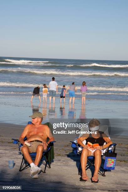 Couple sat on beach chairs on Flagler Avenue Beach.