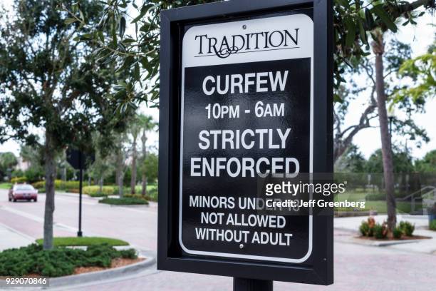 Curfew strictly enforced sign in Tradition.