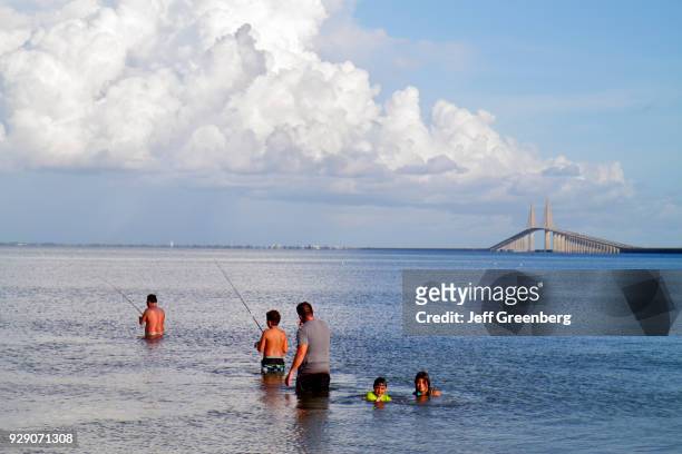 Family fishing in the water at Tampa Bay.
