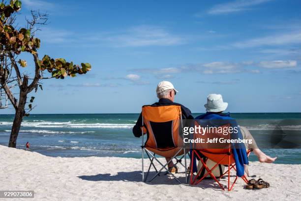 Senior couple sat on chairs on Bathtub Reef Beach.