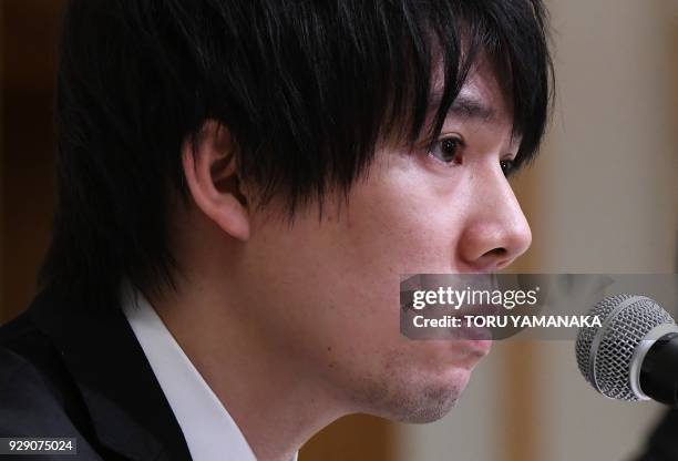 Koichiro Wada, president of Japan's virtual currency exchanges Coincheck, speaks during a press conference in Tokyo on March 8, 2018. - The hack of...