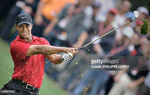 Golfer Tiger Woods hits a ball on the fairway during the HSBC Champions golf tournament in Shanghai on November 8, 2009. Phil Mickelson of the US...