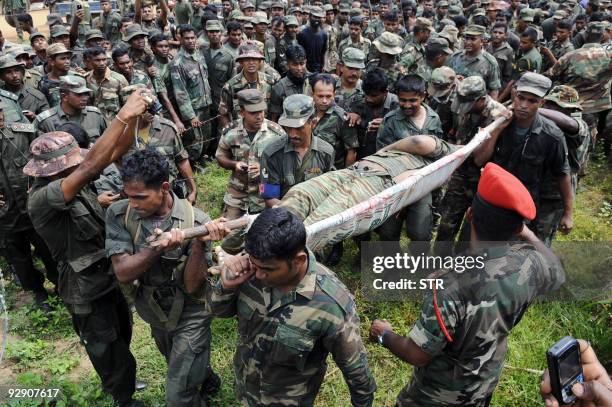 Sri Lankan soldiers carry the remains of what is said to be Tamil Tiger rebel leader Velupillai Prabhakaran in the district of Mullaittivu on May 19,...
