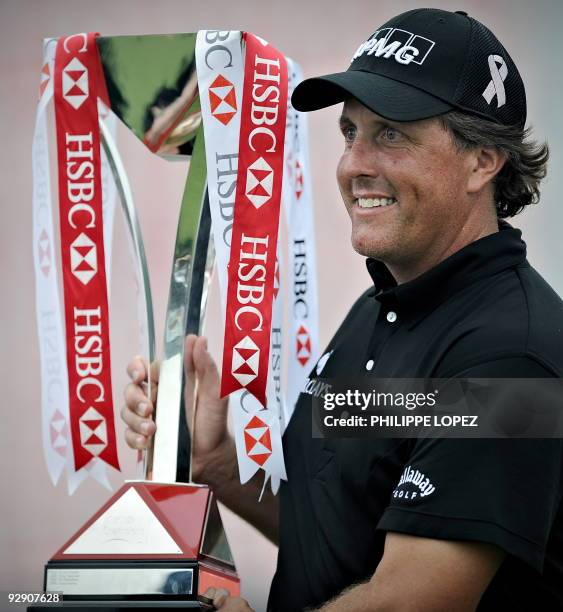 Golfer Phil Mickelson holds the trophy after winning the HSBC Champions golf tournament in Shanghai on November 8, 2009. Phil Mickelson held off a...