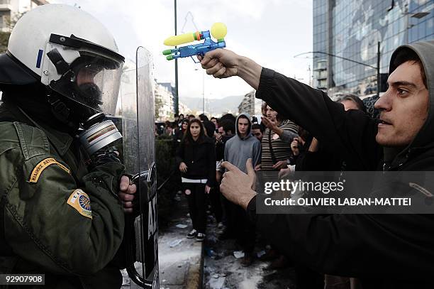 Protester threatens a riot policeman with a water pistol during a demonstration in front of the police headquarters of Athens, on December 15 2008....