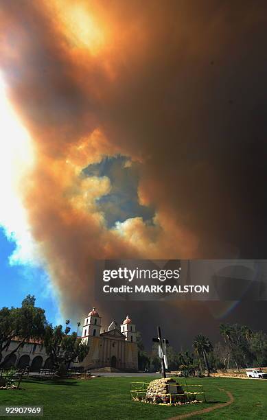 Large smoke cloud shrouds the Santa Barbara Mission building as residents evacuate during the Jesusita Fire in the hills of Santa Barbara, May 6,...