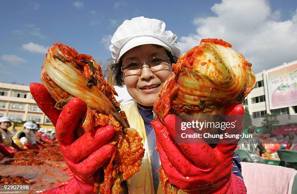 South Koreans make 'kimchi', a traditional pungent vegetable dish, which is donated to the poor in preparation for winter on November 9, 2009 in...