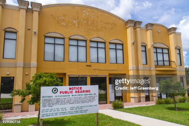 Notice public hearing sign outside a vacant office building in Naples, Florida.