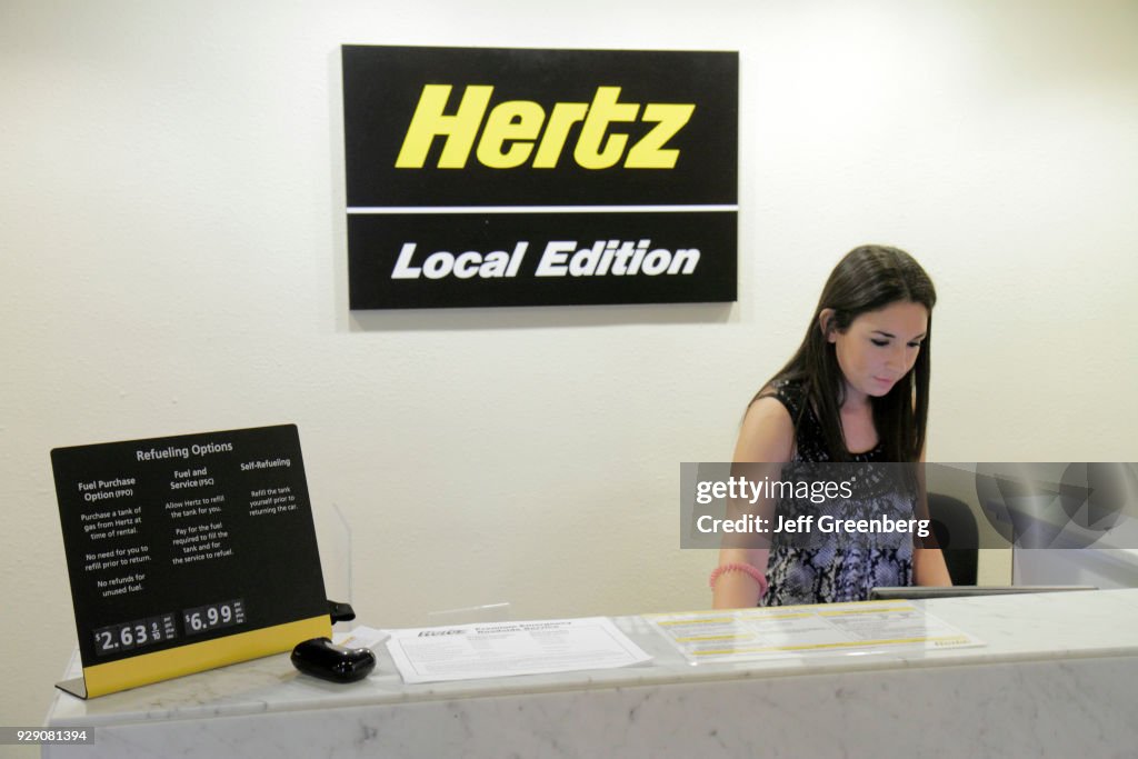 A woman behind the Hertz Rent-a-Car desk at the Marriott Orlando Airport Hotel.