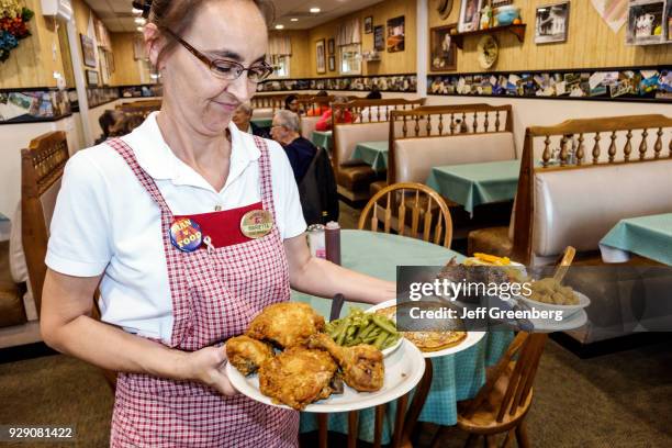 Waitress serving food at Yoder's Amish Village Restaurant.