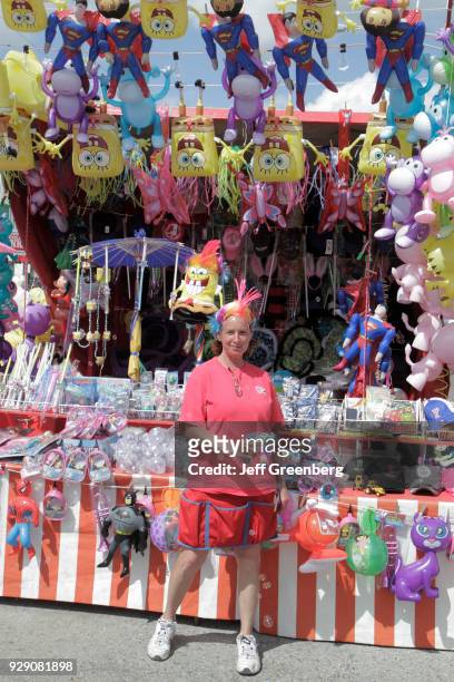 Woman with carnival game prizes at the Florida Strawberry Festival.