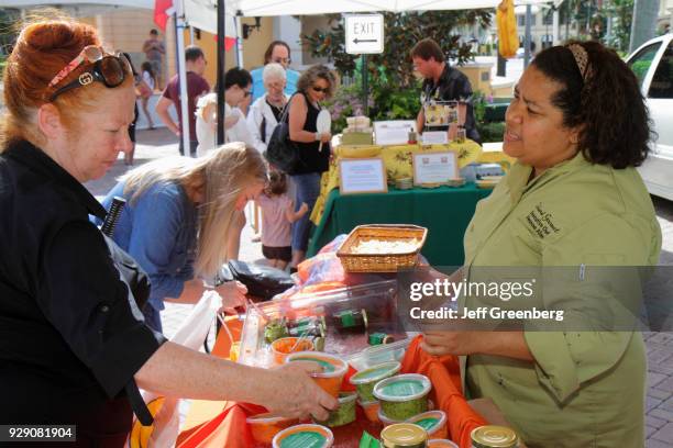 Woman selling condiments at the Saturday GreenMarket at Royal Palm Place.