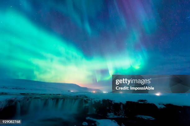 aurora borealis display above the godafoss waterfall, iceland - impossiable fotografías e imágenes de stock