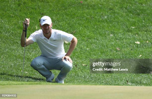 Chris Wood of England lines up a putt on the 3rd green during day one of the Hero Indian Open at Dlf Golf and Country Club on March 8, 2018 in New...