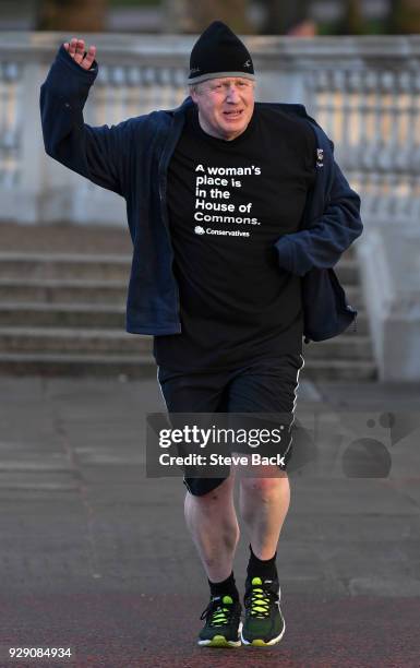 British Foreign Secretary Boris Johnson takes an early morning jog on International Women's Day wearing a T-shirt saying "A woman's place is in the...