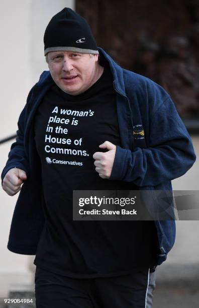 British Foreign Secretary Boris Johnson takes an early morning jog on International Women's Day wearing a T-shirt saying "A woman's place is in the...