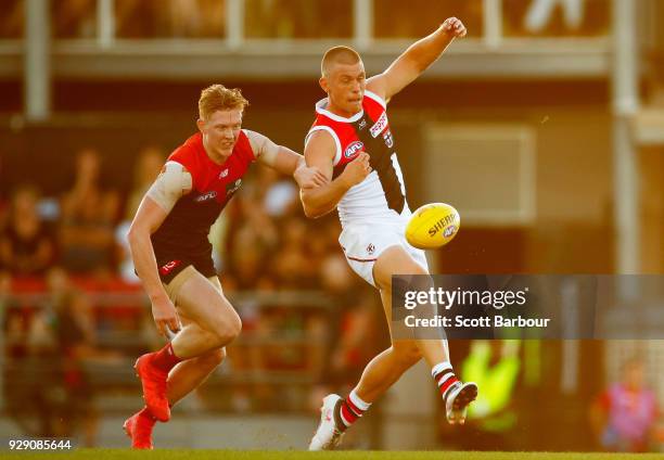 Clayton Oliver of the Demons and Sebastian Ross of the Saints compete for the ball during the JLT Community Series AFL match between the Melbourne...