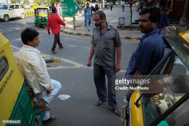 Sunita Choudhary - North India's first auto-rickshaw driver - interacts with male auto-rickshaw drivers waiting for customers outside Patel Chowk...