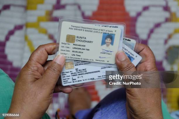 Sunita Choudhary, 40 - North India's first auto-rickshaw driver - holds her various driving permits secured by her over the years on 7th March, 2018....