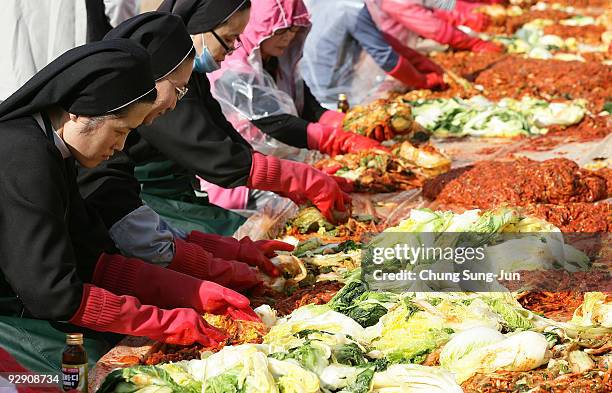 South Korean nuns help other women make 'kimchi', a traditional pungent vegetable dish, which is donated to the poor in preparation for winter on...