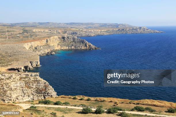 Coastal scenery of cliffs and blue sea looking south from Res il-Qammieh, Marfa Peninsula, Republic of Malta.