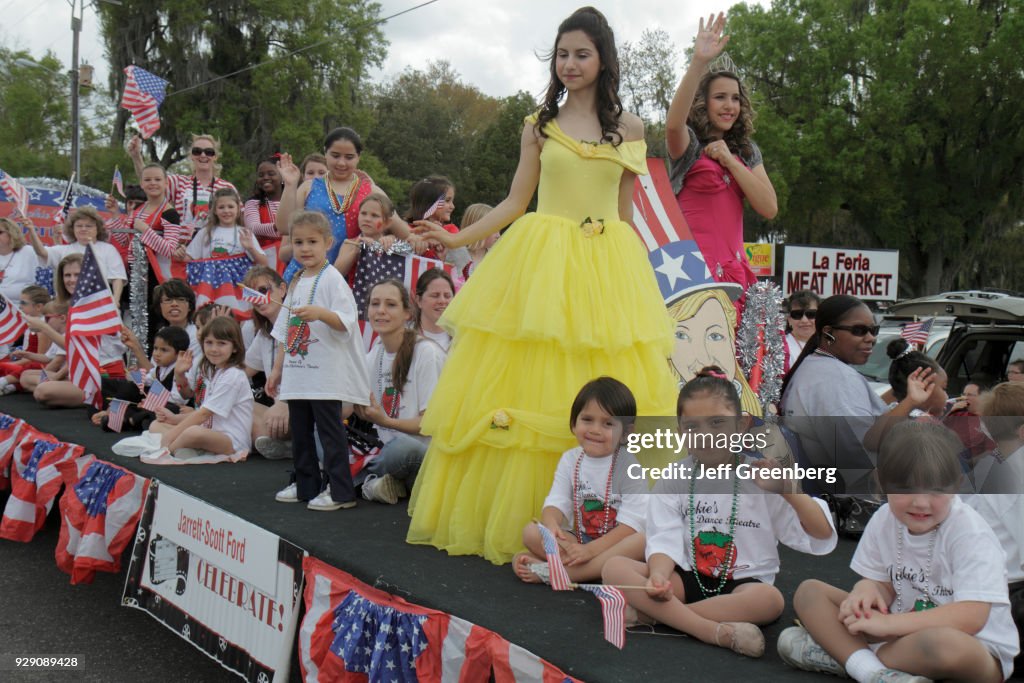 Children with bunting on a float with bueaty queens for the parade at the Florida Strawberry Festival.