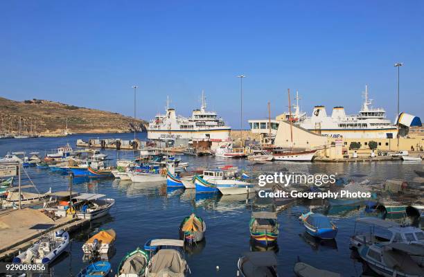Colorful boats in harbor ferry port terminal at Mgarr, island of Gozo, Malta.
