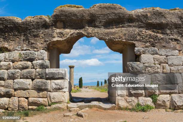 Empuries also known as Ampurias, Girona Province, Catalonia, Spain, Gate leading through the walls to the main street of the Roman town, To the right...