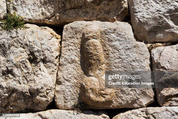 Empuries also known as Ampurias, Girona Province, Catalonia, Spain, Carving of erect penis in wall beside main gate to the Roman town, Such symbols...