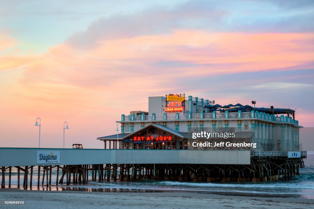Eat at Joe's Crab Shack at sunset.
