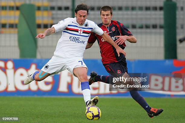 Daniele Dessena of Cagliari competes for the ball with Daniele Mannini of UC Sampdoria during the Serie A match between Cagliari and UC Sampdoria at...