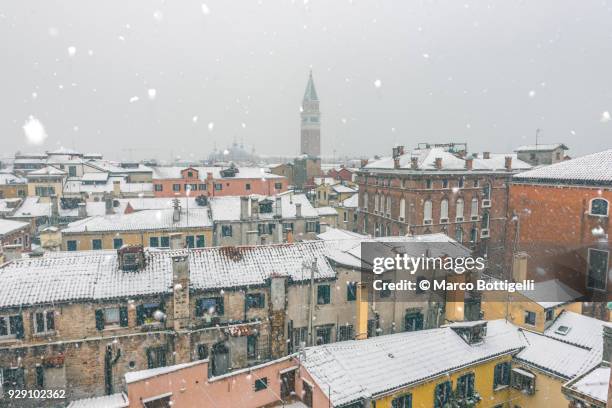 snowcapped roofs. venice, italy. high angle view. - venice winter stock pictures, royalty-free photos & images