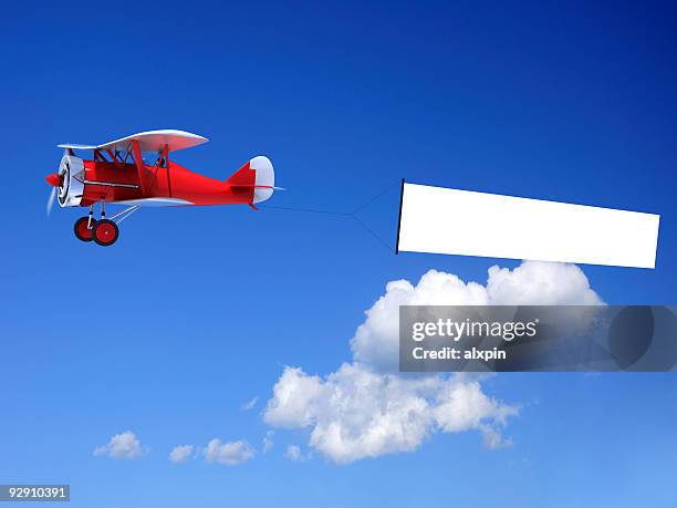 biplane with banner - red plane stock pictures, royalty-free photos & images