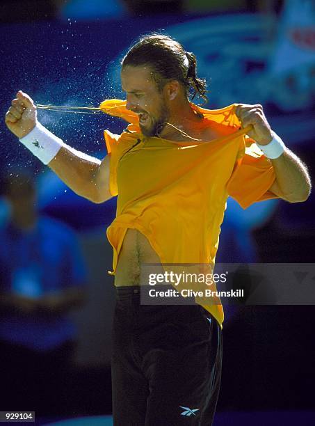 Patrick Rafter of Australia tears his shirt off in celebration of his victory against Tim Henman of the UK, during the seventh day of the Australian...
