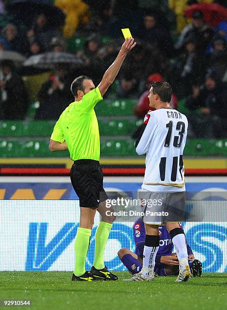 Referee Carmine Russo shows a yellow card to Andrea Coda of Udinese Calcio during the Serie A match between Udinese Calcio and ACF Fiorentina at...