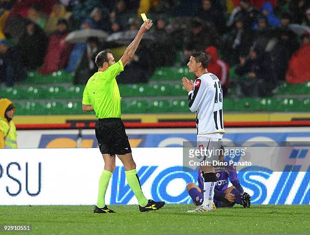 Referee Carmine Russo shows a yellow card to Andrea Coda of Udinese Calcio during the Serie A match between Udinese Calcio and ACF Fiorentina at...