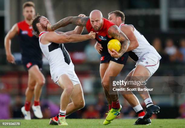 Nathan Jones of the Demons is tackled by Jack Steven of the Saints during the JLT Community Series AFL match between the Melbourne Demons and the St...