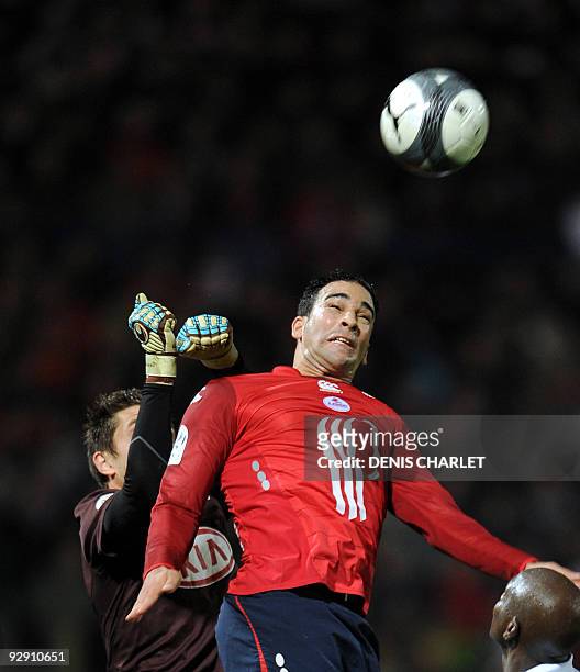Lille defender Adil Rami vies with Bordeaux goalkeeper Cedric Carasso during the French L1 football match Lille vs Bordeaux on November 8, 2009 at...