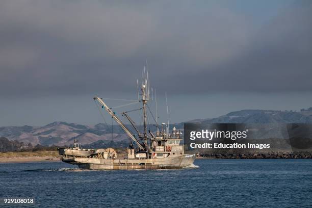 Fishing boat leaving Morro Bay, San Luis Obispo County, California, USA.