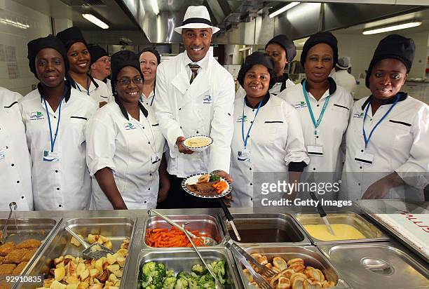 Colin Jackson OBE poses with Britain's favourite school meal and the catering staff from Morpeth School at the Launch of National School Meal Week on...
