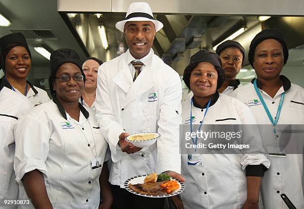 Colin Jackson OBE poses with Britain's favourite school meal and the catering staff from Morpeth School at the Launch of National School Meal Week on...