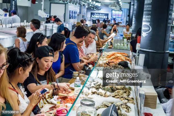 New York City, Chelsea Market, The Lobster Place Seafood Market, raw bar with diners.