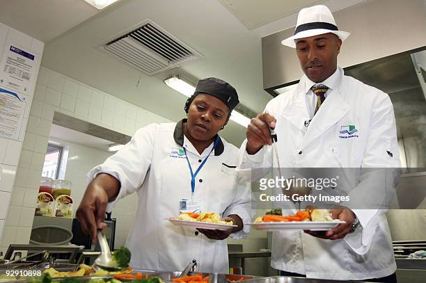 Colin Jackson OBE serves Britain's favourite school meal alongside the catering staff from Morpeth School at the Launch of National School Meal Week...