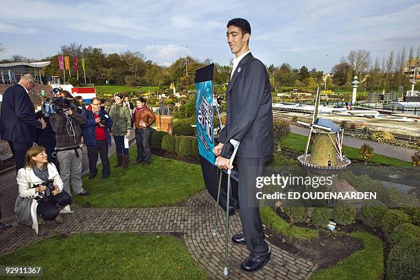 The tallest man in the world Sultan Kosen , of Turkey, poses on November 9, 2009 at Madurodam miniature park in The Hague. Kosen, who measures 2.46...