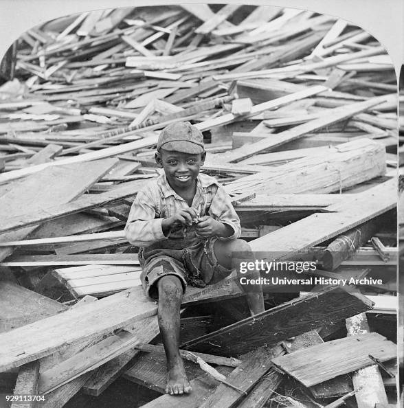 Portrait of Young Boy Sitting on Pile of Debris after Hurricane ...