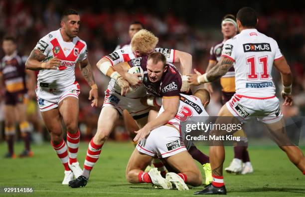 Matthew Lodge of the Broncos is tackled during the round one NRL match between the St George Illawarra Dragons and the Brisbane Broncos at UOW...