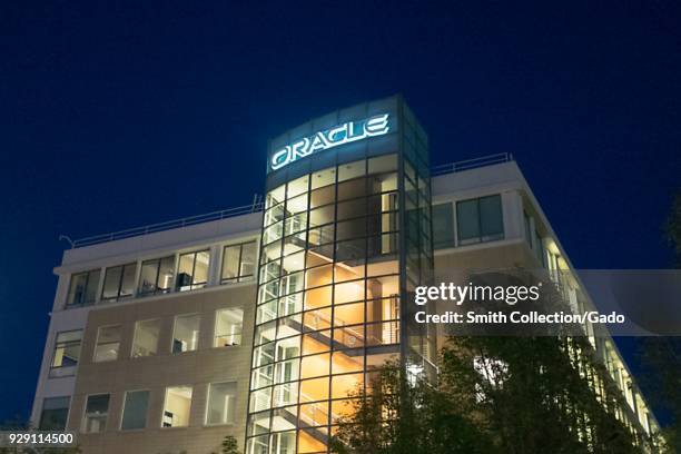 Facade with sign and logo at night at regional headquarters of technology company Oracle in the San Francisco Bay Area, Dublin, California, March 5,...