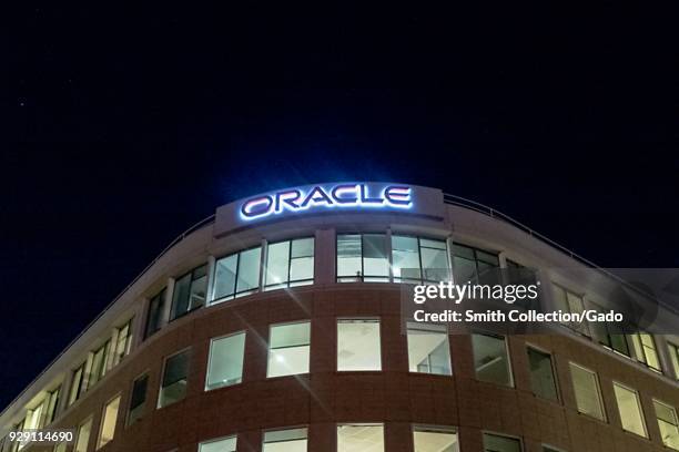 Facade with sign and logo at night at regional headquarters of technology company Oracle in the San Francisco Bay Area, Dublin, California, March 5,...